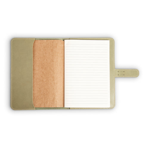 DuPage journal open to show lined paper refill on right and natural vachetta leather slip pocket on left, inside aqua green Iphitos buffalo leather cover with cream stitching.
