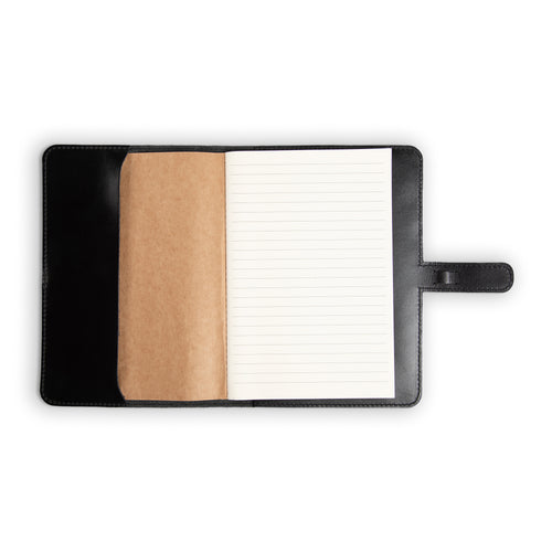 DuPage Black journal open to show lined paper refill on right and natural vachetta leather slip pocket on left, inside black Dexios calfskin cover with black perimeter stitching. 