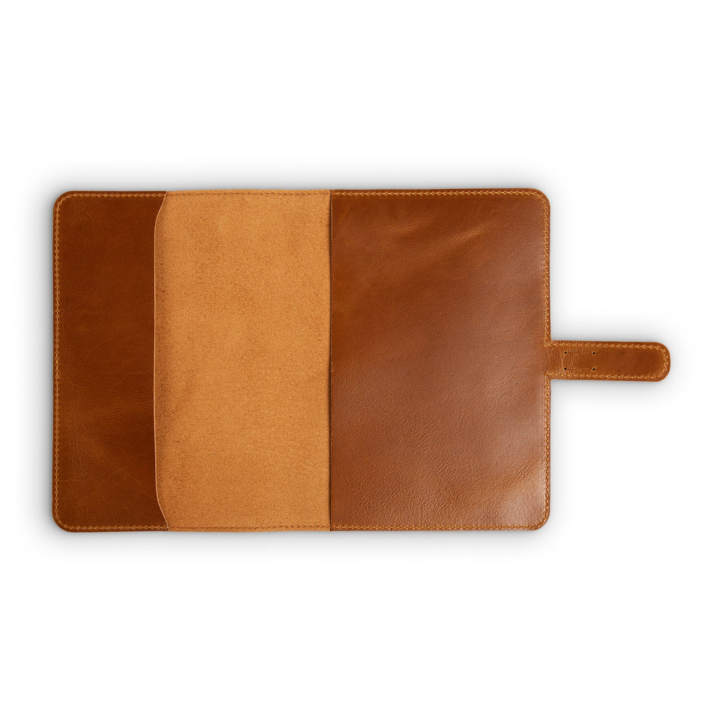 Interior of mustard brown DuPage leather journal fully open and empty, showing warm tan Dexios pull-up calfskin lining on both panels with natural vachetta slip pocket on left side.