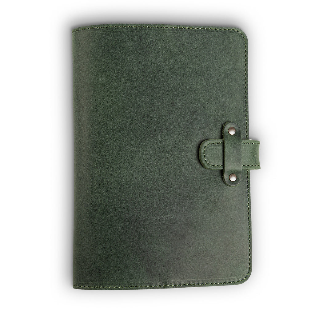Forest green Dallas Crazy Horse leather journal, front cover view, showing waxy pull-up surface with natural tonal variation, green saddle stitching, and antique brass rivet strap closure on right side.