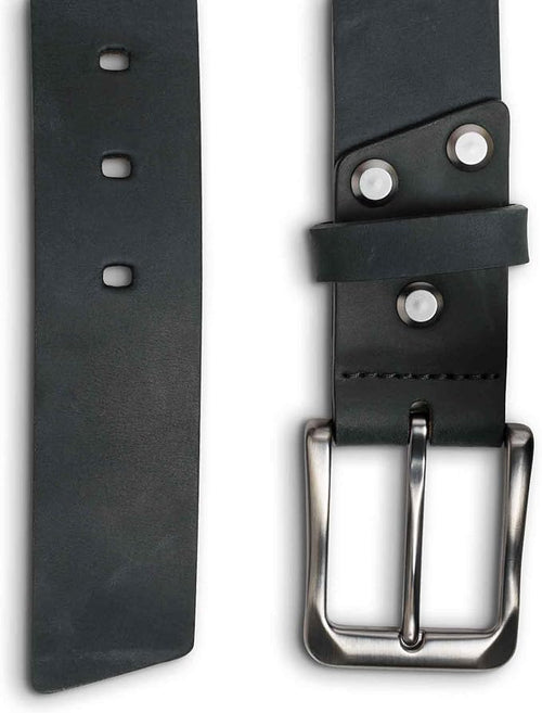 Close-up split view of the charcoal black leather belt. Left side shows the angled belt tip with three rectangular punch holes on the smooth waxy strap. Right side shows the brushed nickel buckle with two silver rivets securing the keeper loop and black saddle stitching along the edge.