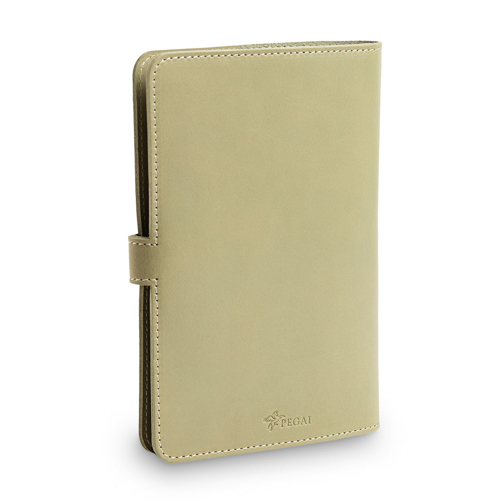 Three-quarter front view of closed aqua green DuPage journal showing spine thickness, cream saddle stitching, side strap closure tab, and embossed PEGAI logo on lower front cover.