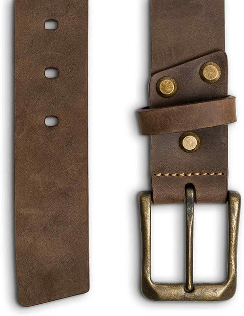 Close-up split view of chestnut brown leather belt: oval punch holes on left panel; antique brass buckle, brass rivets, keeper loop, and tan saddle stitching on right panel. 