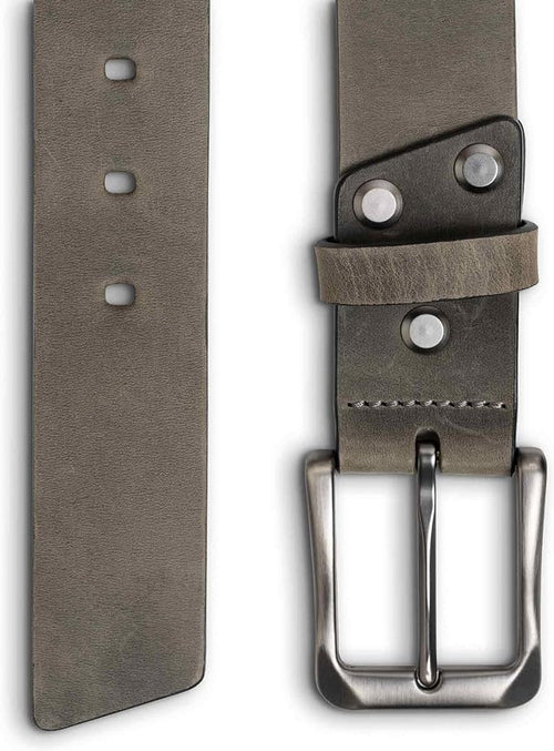 Close-up split view of rock gray leather belt: oval punch holes on left panel; brushed nickel buckle, silver-tone rivets, keeper loop, and gray saddle stitching on right panel.
