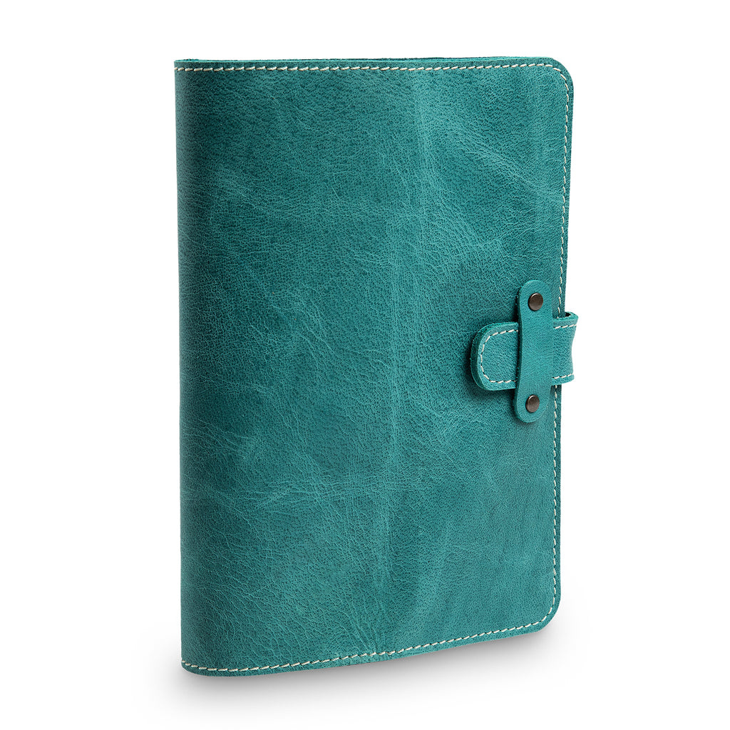 Three-quarter angled view of closed turquoise green DuPage journal highlighting the leather strap closure with antique brass rivets, cream stitching, and distressed Laodamas buffalo surface.