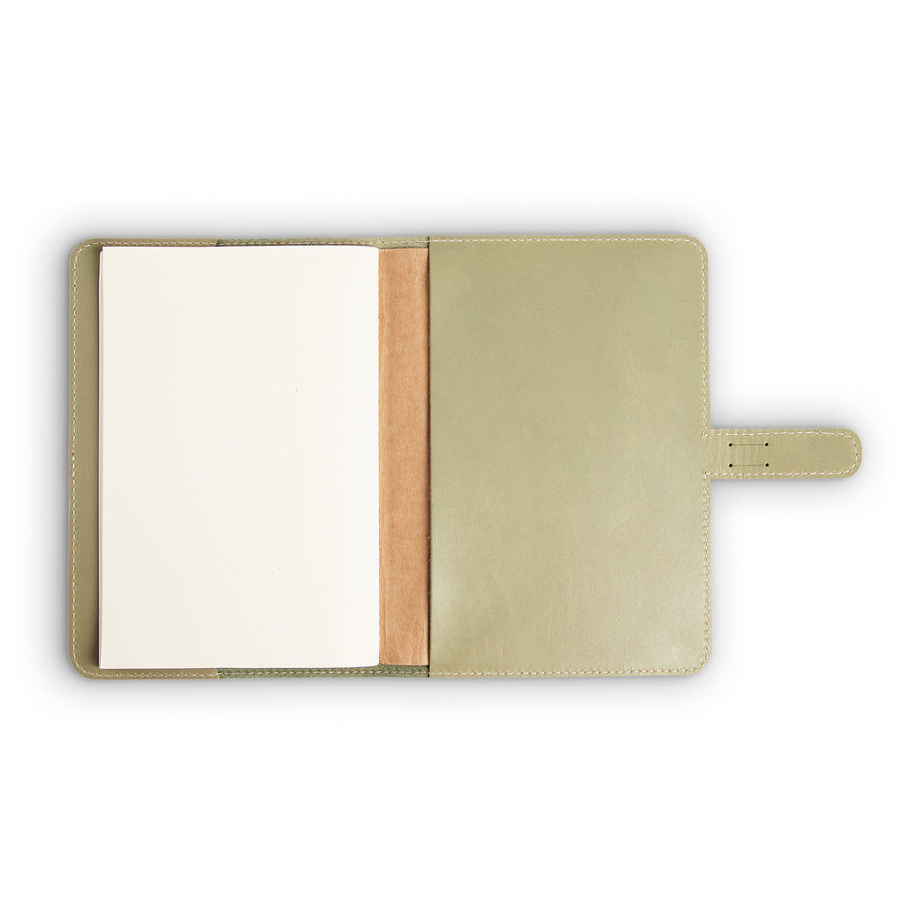 DuPage journal open to show blank white paper refill on left panel and smooth aqua green pull-up buffalo leather interior on right, with natural vachetta spine and cream perimeter stitching.