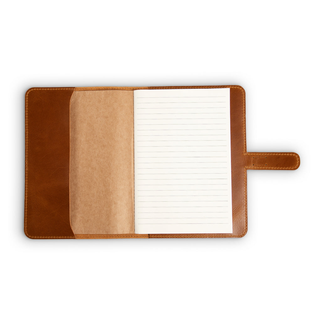 DuPage Mustard Brown journal open to show lined paper refill on right, natural vachetta leather slip pocket at center, and warm tan Dexios pull-up leather interior on left, with strap tab visible.