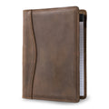 Eriksen Jr. Padfolio in Sand Brown Dallas Crazy Horse leather stands upright, closed, showing curved seam stitching and a lined legal pad peeking from the right edge.