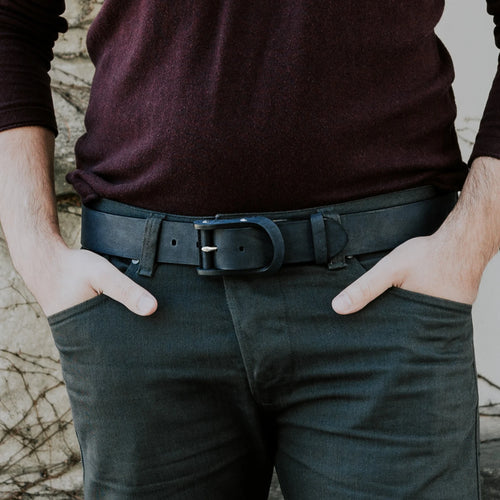 Man wearing a charcoal black handcrafted leather belt with casual trousers and dark sweater