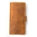 Clark Leather Checkbook Cover in Cinnamon Brown, closed and laid flat on a white surface. Dallas Crazy Horse calfskin in a warm golden cinnamon tone with natural waxy pull-up surface variation and subtle hide markings. Vivid amber-toned saddle stitching runs along all four edges. A small leather tab with an antique brass snap closure sits centered on the right edge.