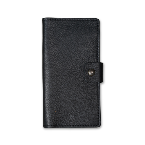 Clark Leather Checkbook Cover in Dymnos Black, closed on white. Full-grain calfskin with visible pebbled grain texture and pull-up finish. Tonal dark stitching on all edges. Antique brass snap tab on right.