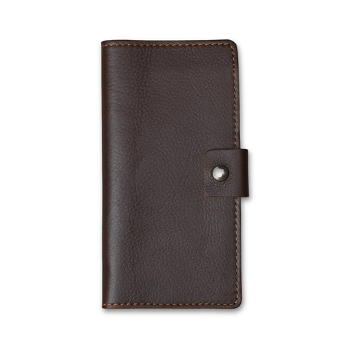Clark Leather Checkbook Cover in Dymnos Brown, closed on white. Full-grain calfskin with pebbled grain texture and rich pull-up finish. Warm tonal saddle stitching on all edges. Antique brass snap tab on right.
