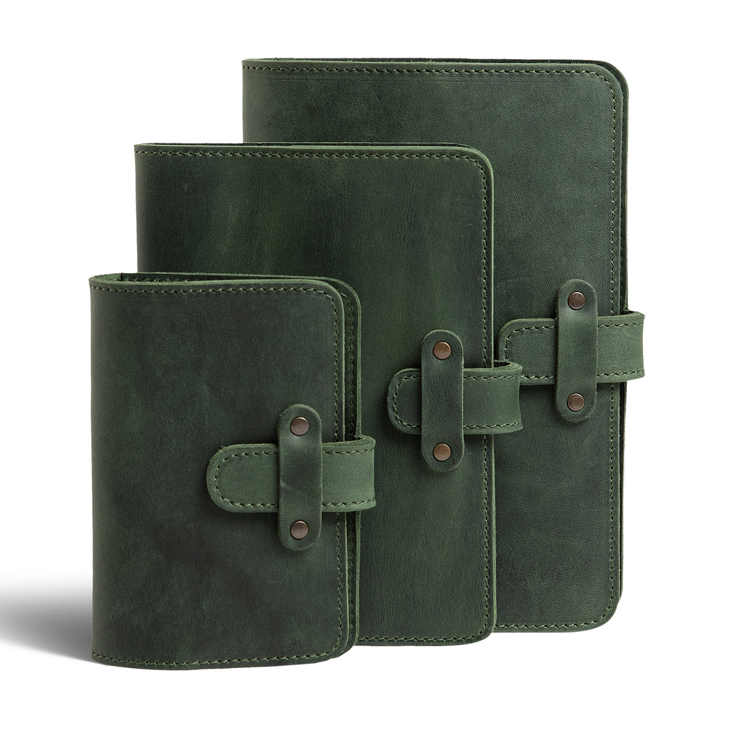 Three DuPage leather journals in forest green displayed together showing Pocket, Midi, and Full size comparison, all with matching green stitching and antique brass rivet strap closures. 