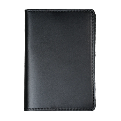 Dual tone black leather passport cover, closed and laid flat. Smooth glossy pull-up surface with subtle tonal variation revealing deep charcoal and near-black blending. Hand-stitched edges in matching black thread. Rounded corners and clean minimal silhouette.