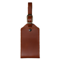 Tan DT Lux leather luggage tag with antique brass buckle and adjustable travel strap