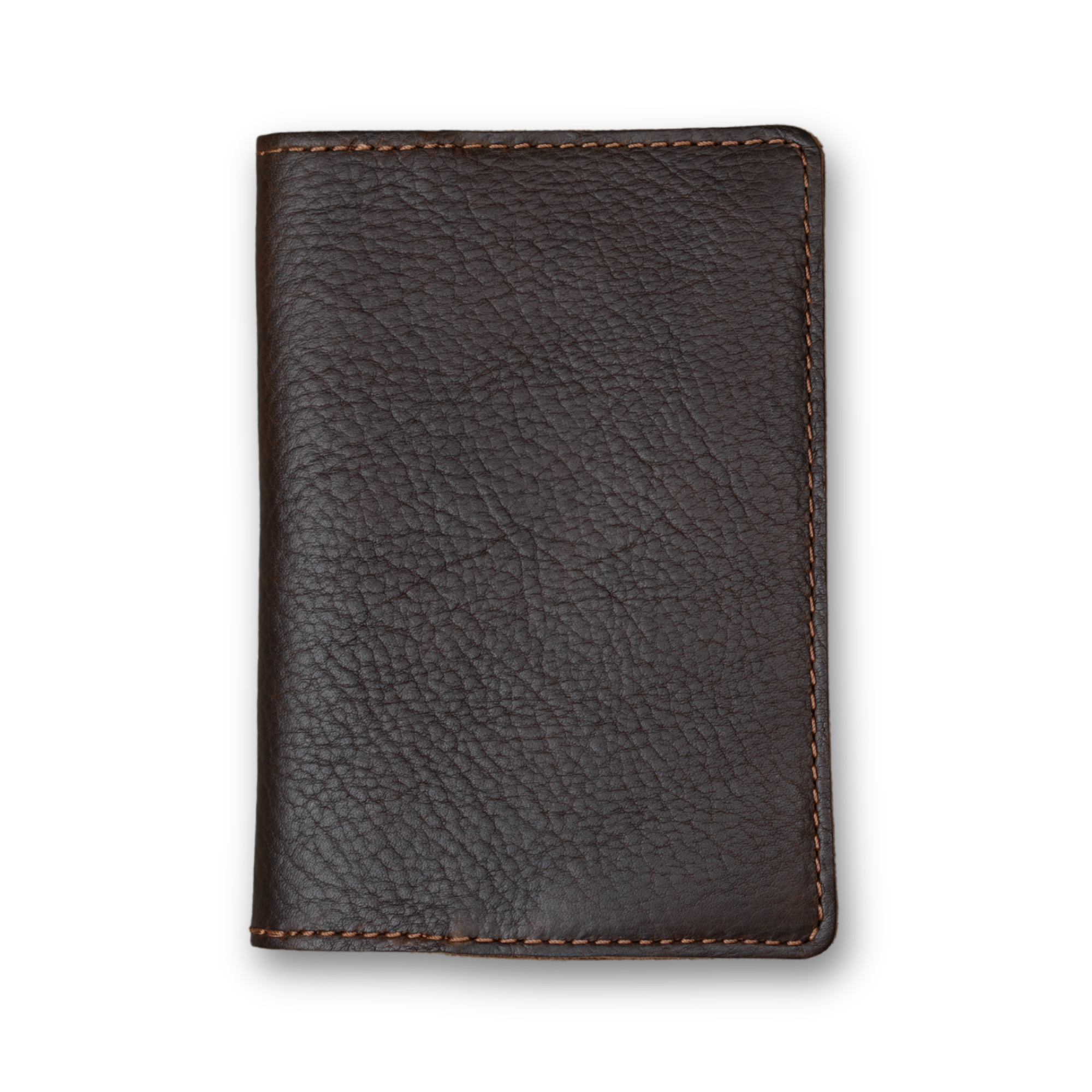 Dymnos brown full-grain calfskin passport cover, closed and laid flat. Deep espresso brown pebbled surface with organic grain movement throughout. Hand-stitched edges in contrasting warm brown thread. Rounded corners and clean minimal silhouette with no hardware or closures.