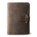 Chestnut brown Dallas Crazy Horse leather journal, front cover without personalization, showing waxy pull-up surface, natural markings, antique brass rivet strap closure, and tan saddle stitching.