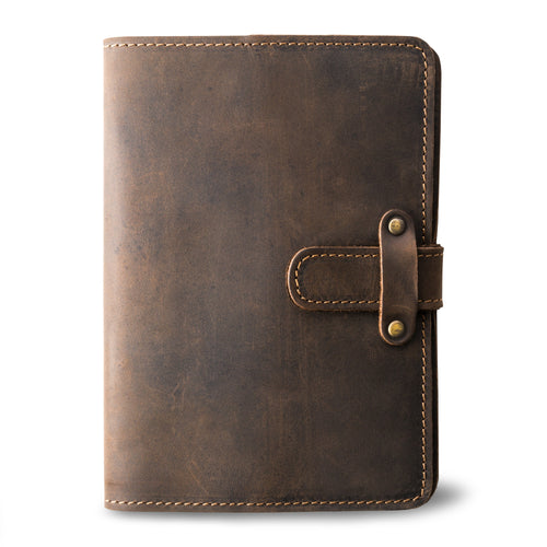 Chestnut brown Dallas Crazy Horse leather journal, front cover without personalization, showing waxy pull-up surface, natural markings, antique brass rivet strap closure, and tan saddle stitching.