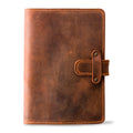 Mahogany Dallas Crazy Horse leather journal, front cover view, showing heavily distressed warm brown waxy pull-up surface with natural markings, orange saddle stitching, and antique brass rivet strap closure.