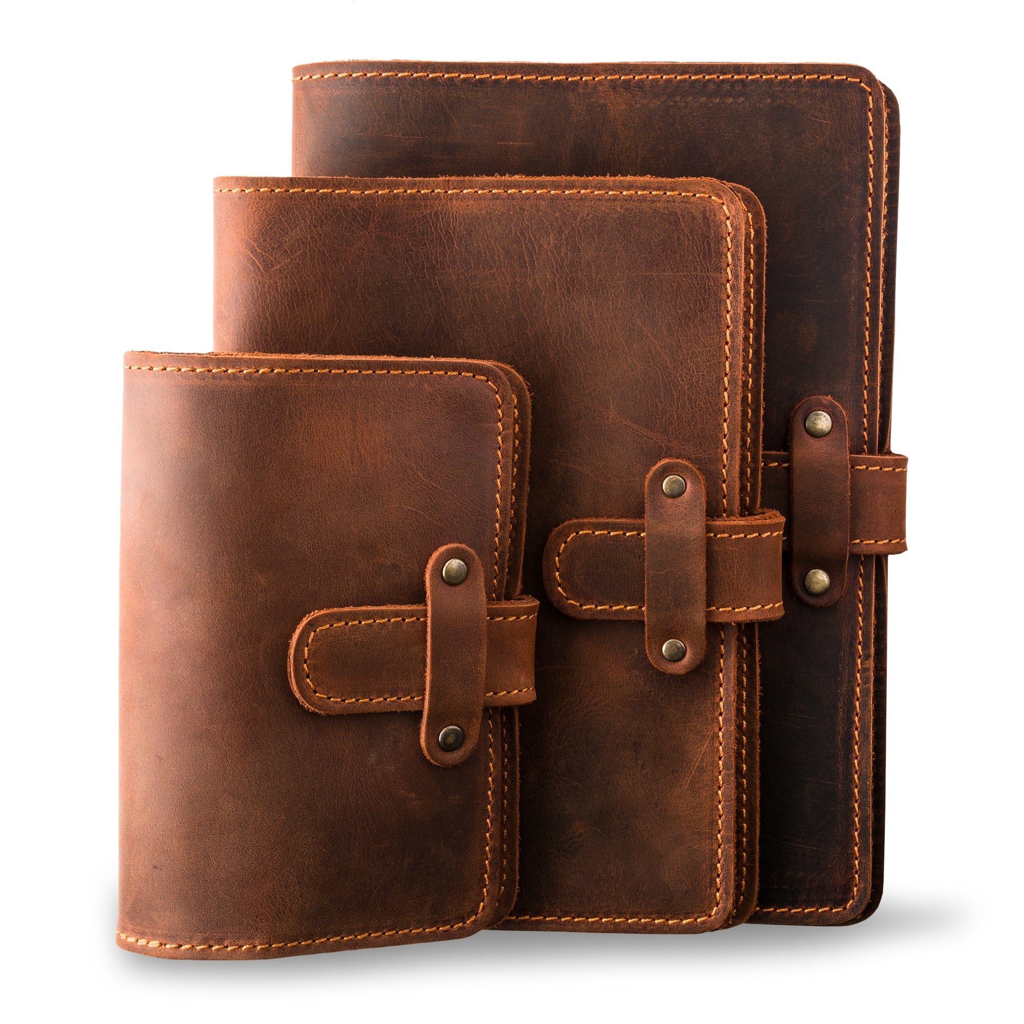 Three DuPage leather journals in mahogany showing Pocket, Midi, and Full size comparison, all with matching orange saddle stitching, antique brass rivets, and heavily distressed warm brown pull-up surfaces.