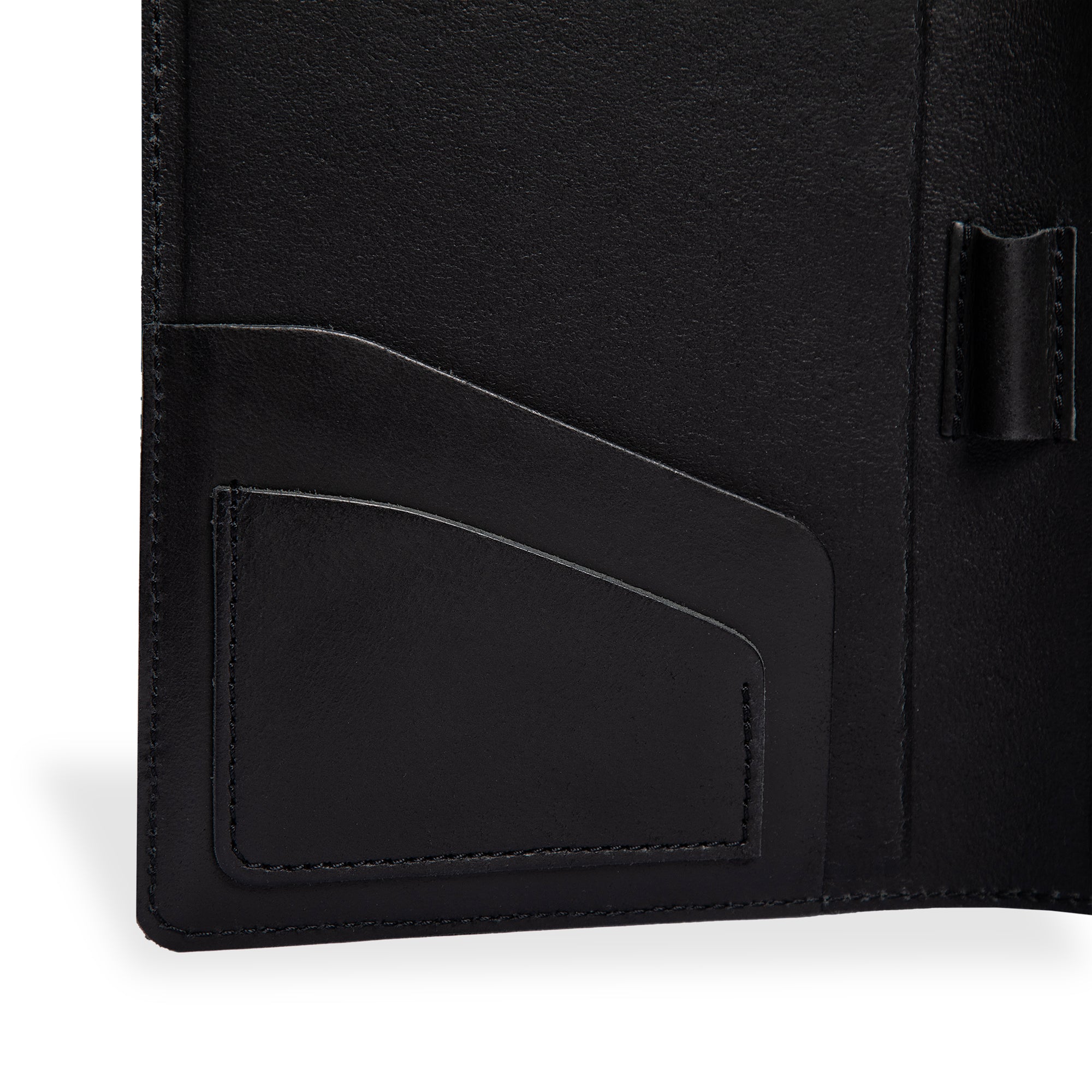 Close-up of PEGAI Eriksen Jr. padfolio interior in charcoal black Iphitos buffalo leather, showing angled business card slot stitching and central pen loop detail. 