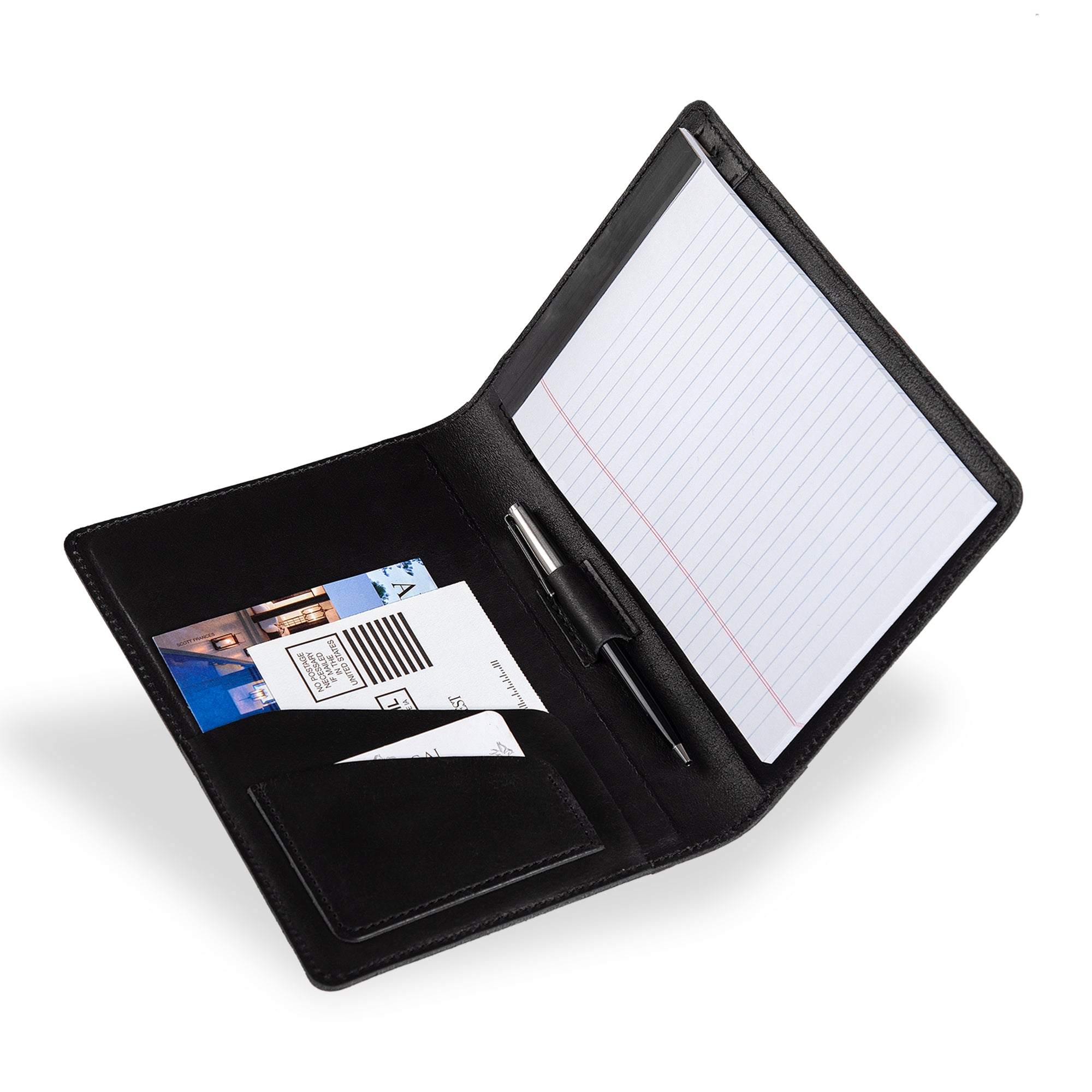 PEGAI Eriksen Jr. padfolio open and in use, holding a lined legal pad, a pen in the center loop, and postcards and a card tucked in the left interior pocket. 