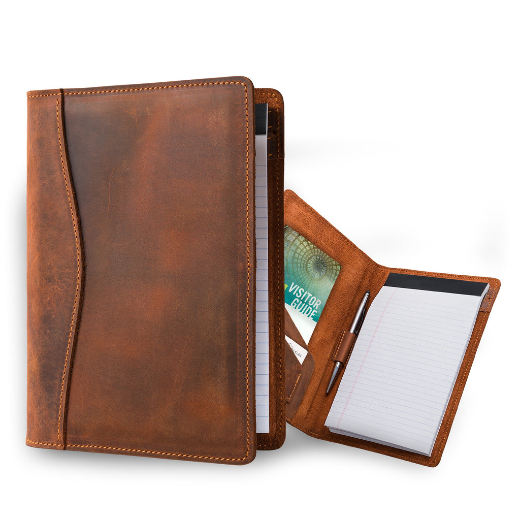 Two PEGAI Eriksen Jr. padfolios in mahogany Dallas Crazy Horse leather: one standing closed with legal pad inside, one open showing visitor guide, cards, pen, and notepad. 