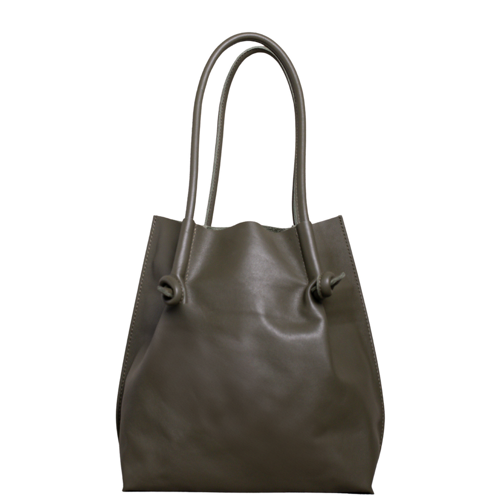 Flora Everyday Tote in Smooth Calf Green stands upright with a soft, fine-grain finish, dual rolled handles, and a single knotted leather closure on each side.