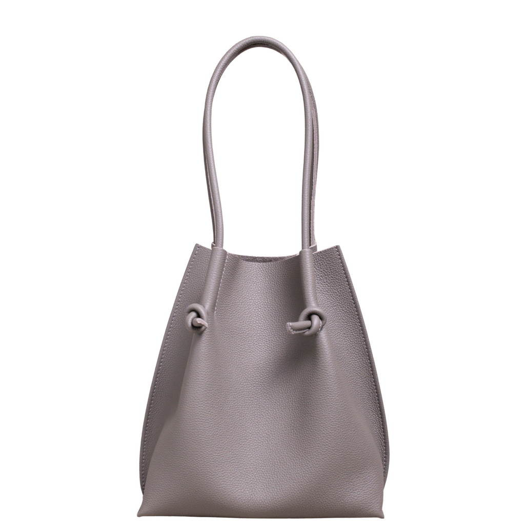 Flora Everyday Leather Tote in Togo Calf Gris, front view on white background. Structured bucket-style tote with tall rolled leather handles and two knotted leather ties cinching the open top.