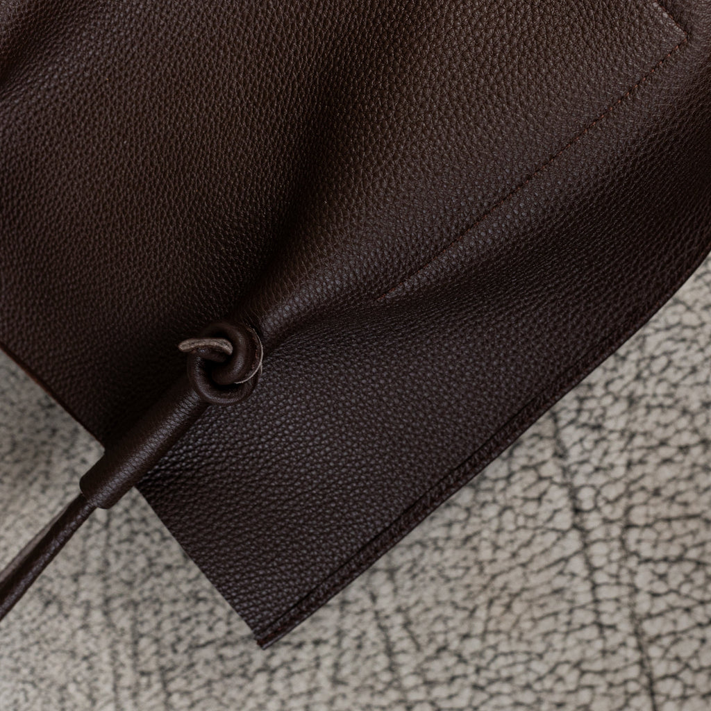 Flora Everyday Leather Tote in Togo Calf Brown with raw suede interior, rolled handles, and folded edge details—crafted for timeless, daily use.