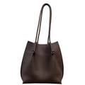 Flora Everyday Leather Tote in Togo Calf Brown, front view on white background. Structured bucket-style tote with tall rolled leather handles and two knotted leather ties cinching the open top.