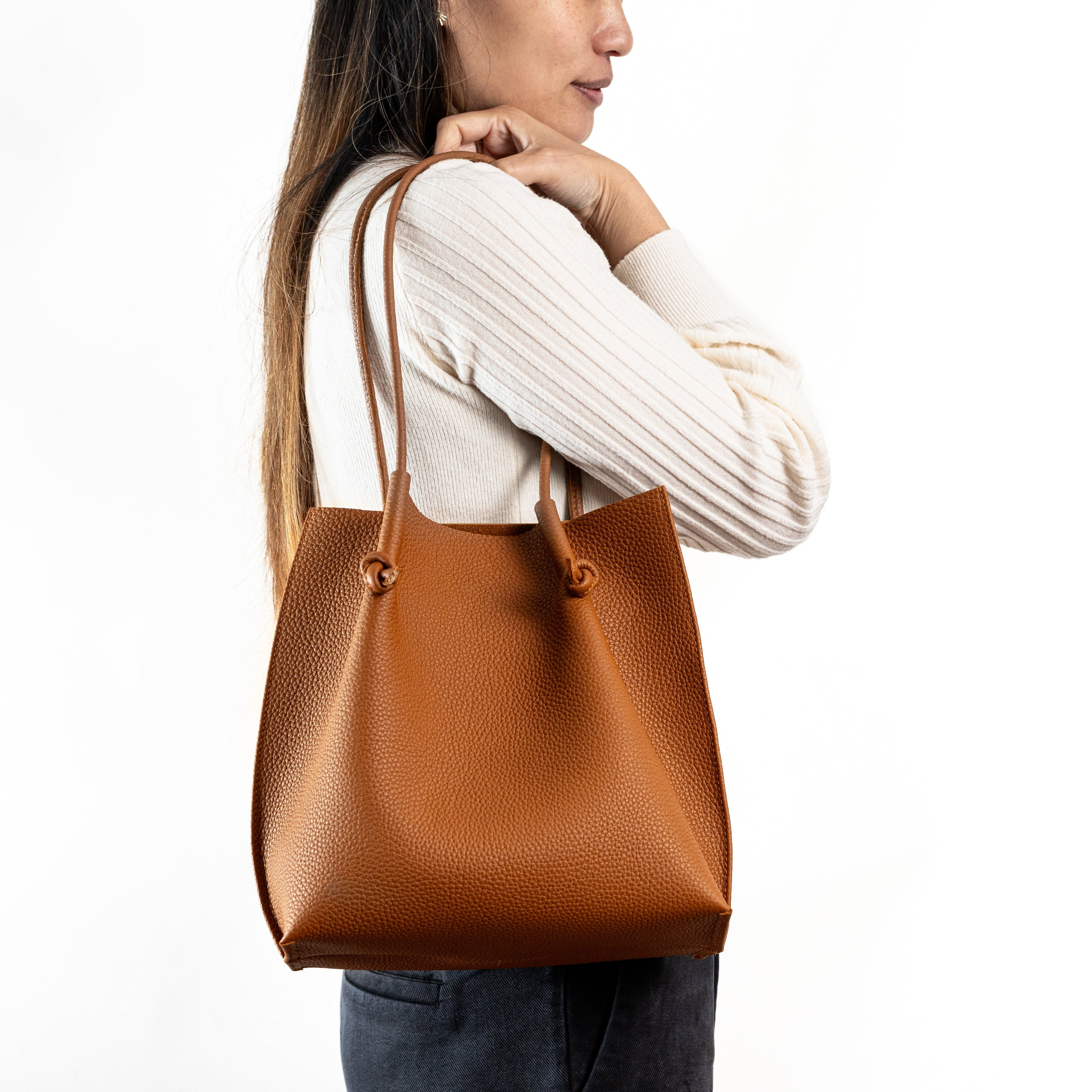 Flora Everyday Leather Tote in Togo Calf Taba with suede interior, rolled handles, and hand-finished edges—crafted for everyday function and rustic charm.