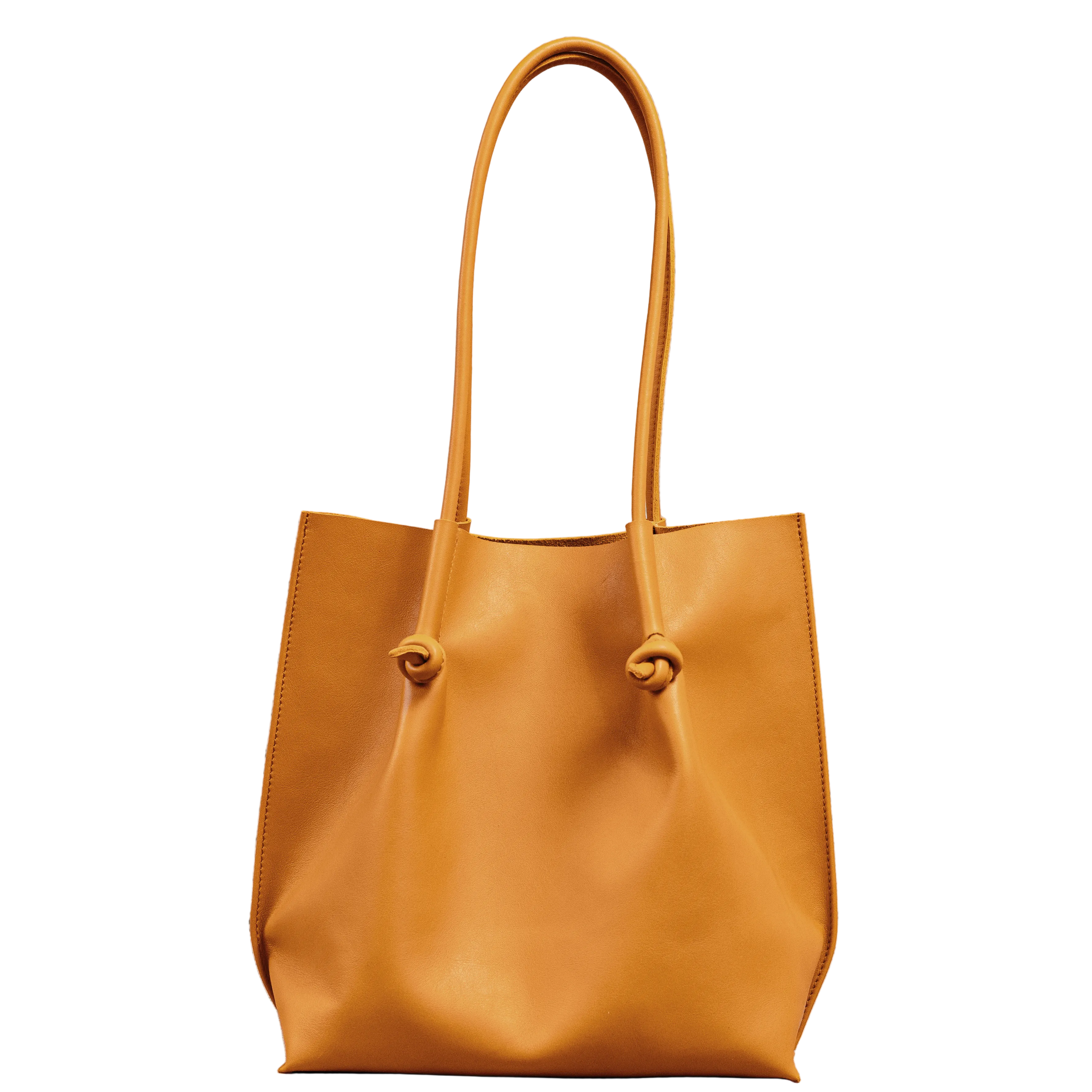 Flora Everyday Tote in Smooth Calf Orange stands upright with a soft, fine-grain finish, dual rolled handles, and a single knotted leather closure on each side.