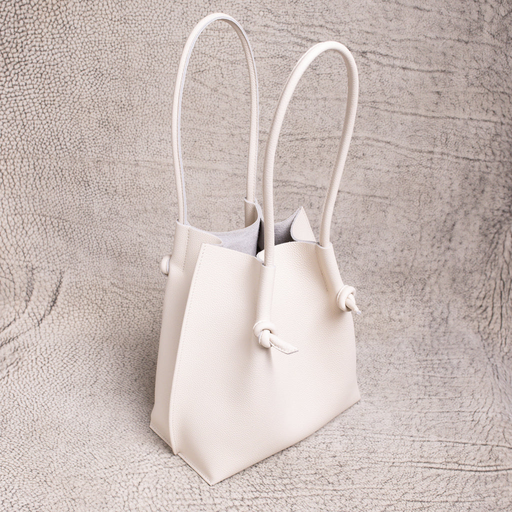 Three-quarter angle of the Beige Flora Tote highlighting its structure and long handles.