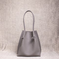 Front-facing view of the Flora Everyday Tote in Togo Gris, showing its softly structured form and knotted leather handles.