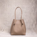 Front view of the Flora Tote in Togo Etoupe leather, displaying its structured silhouette and soft pebbled texture.