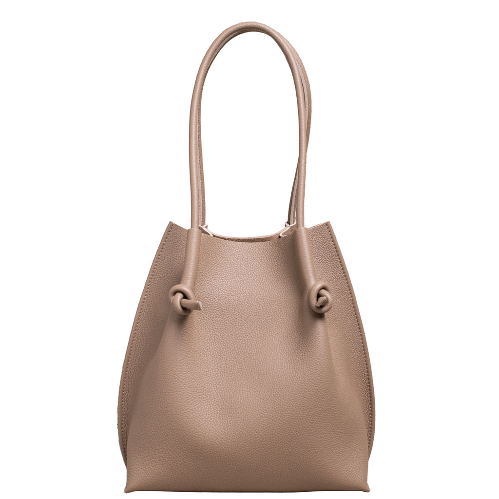 Flora Everyday Leather Tote in Togo Calf Etoupe, front view on white background. Structured bucket-style tote with tall rolled leather handles and two knotted leather ties cinching the open top.