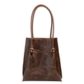 Flora Everyday Tote in Dual Tone Coffee leather stands upright, tall silhouette, with rolled dual handles and a single knotted leather closure on each side of the open top.