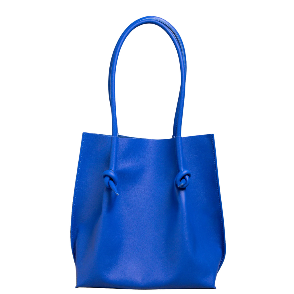 Flora Everyday Tote in Smooth Calf Blue stands upright with a soft, fine-grain finish, dual rolled handles, and a single knotted leather closure on each side.