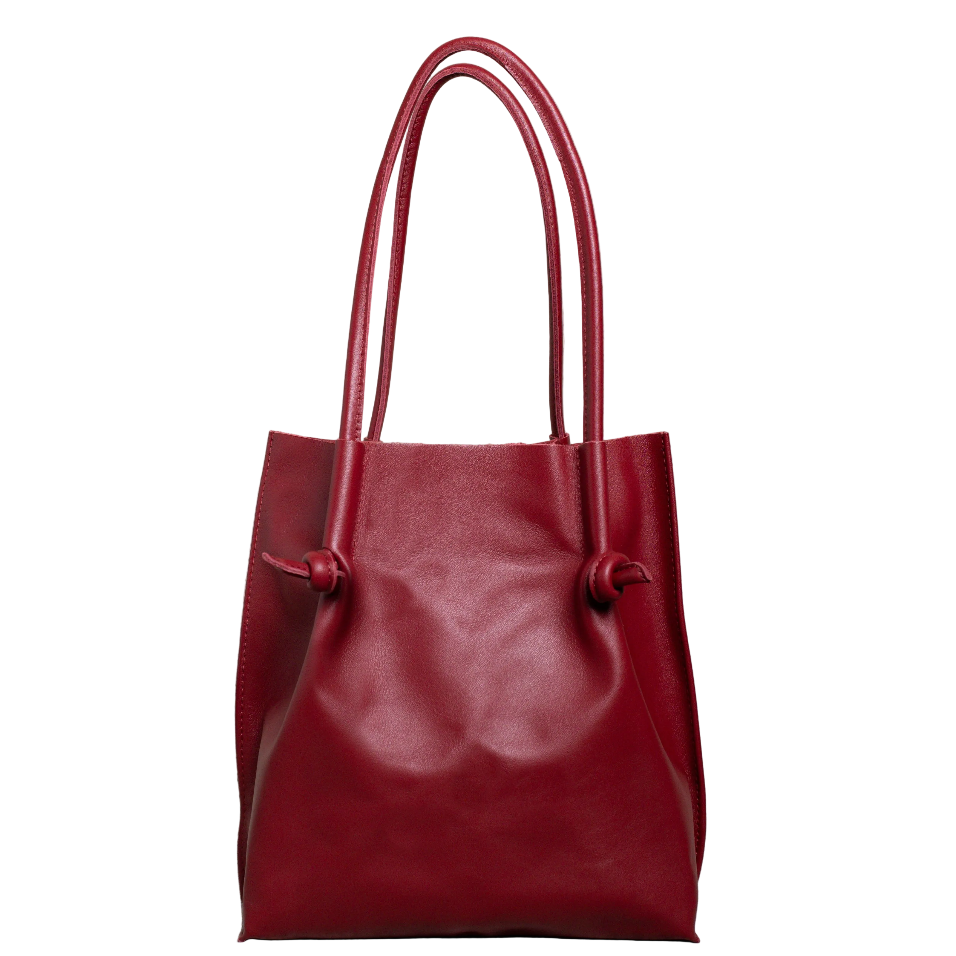 Flora Everyday Tote in Smooth Calf Burgundy stands upright with a soft, fine-grain finish, dual rolled handles, and a single knotted leather closure on each side.