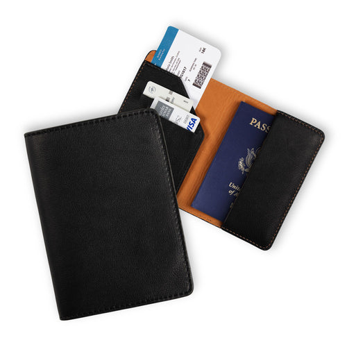 Two black leather passport wallets on white: one closed showing the smooth pebbled exterior, one open displaying the warm tan leather lining, diagonal card pocket on the left, and a U.S. passport with boarding pass and debit card inserted. Brown contrast stitching throughout.