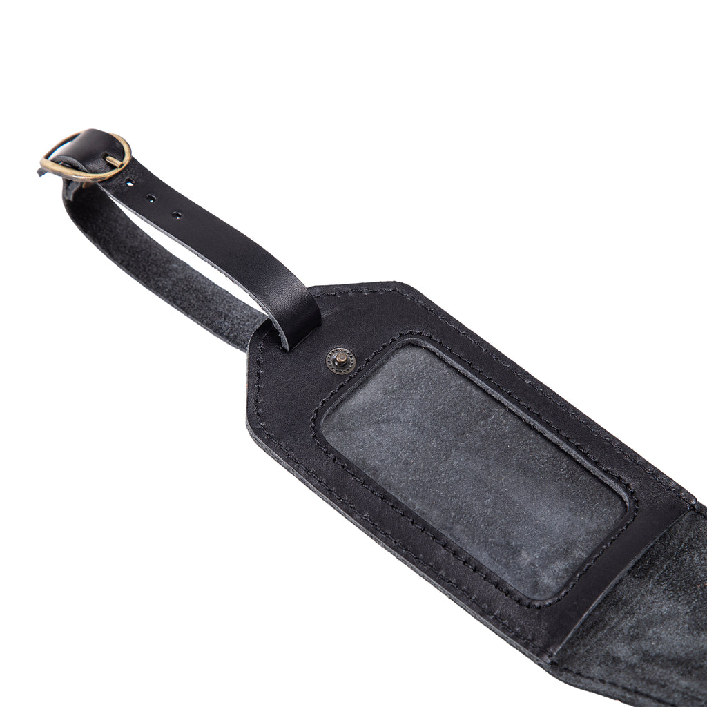 Black leather luggage tag interior with clear identification window and suede backing