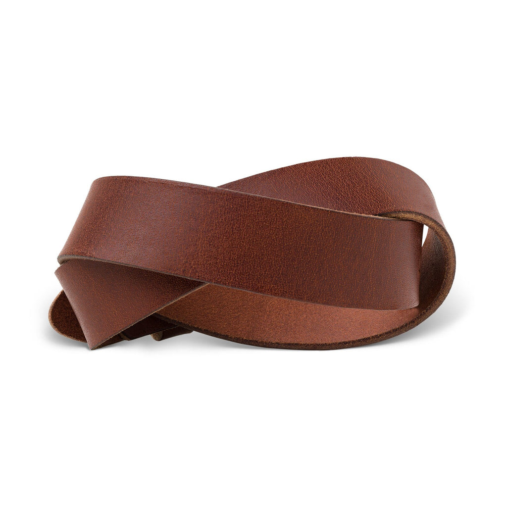 Buffalo Leather Belt in Rustic Brown twisted into a sculptural loop to reveal both grain and flesh sides simultaneously. Warm chestnut outer grain contrasts with the lighter, more matte inner surface. Natural hide texture and subtle pull-up tonal shifts visible across both faces.