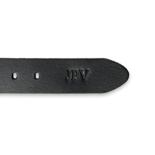 Close-up of the tip end of the Buffalo Leather Belt in Black showing fire-branded personalization. Three bold initials "JPV" embossed in Times New Roman near the belt tip, surrounded by adjustment holes and visible natural buffalo hide grain texture.