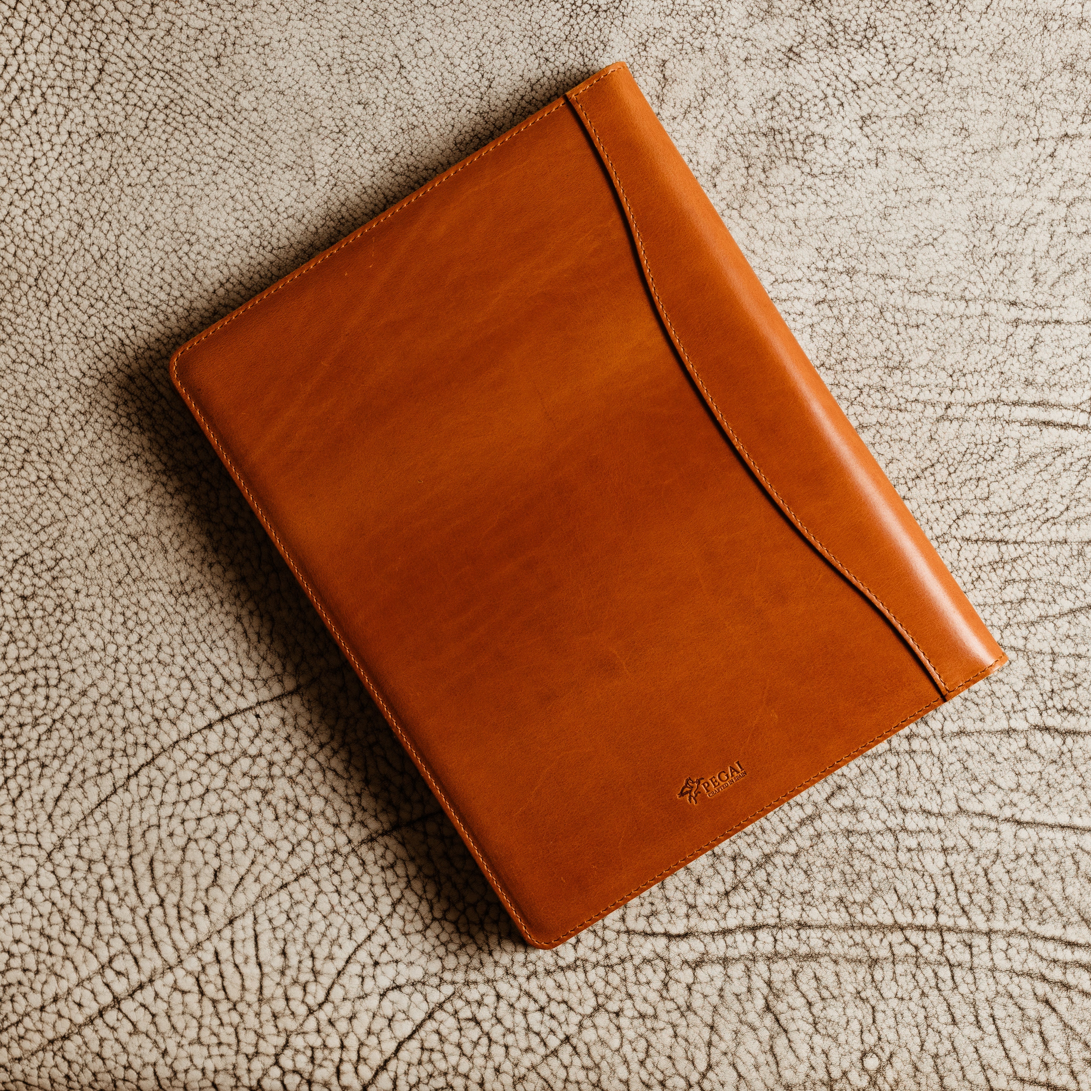 Handcrafted leather padfolio in Whiskey Cognac with pen holder, card pocket, and folder slot—designed by Tanner Leatherstein for legal pads.