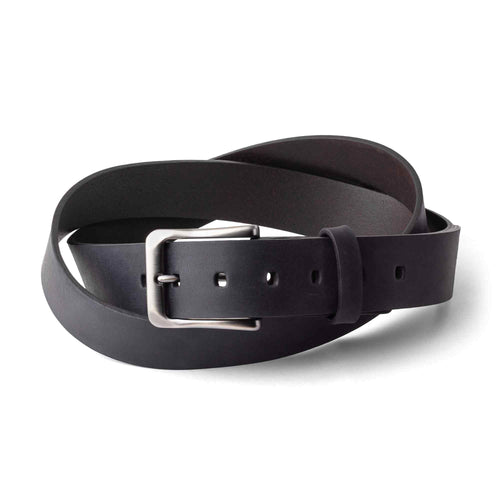 Charcoal black top-grain leather belt coiled on white background. Smooth waxy Dallas Crazy Horse surface with natural character marks. Brushed nickel rectangular roller buckle with rounded corners. Visible punch holes along the strap and a leather keeper loop near the buckle.